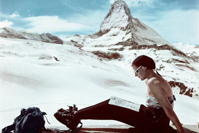 Skier sunbathes in front of Mottarone.