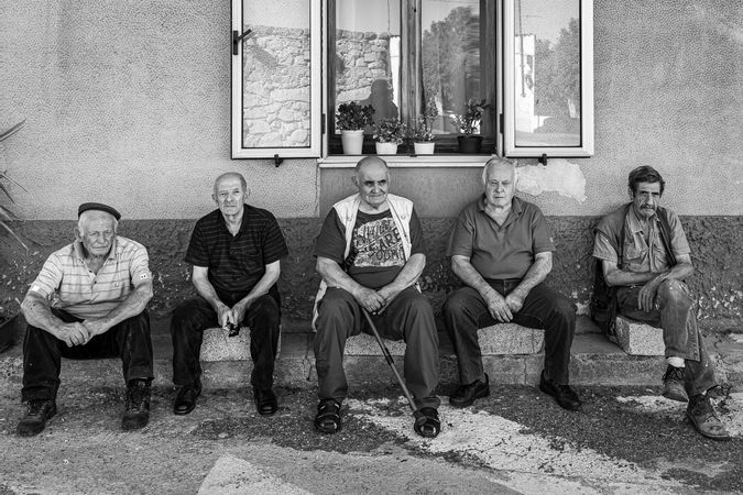 Elderly people on ancient granite chairs