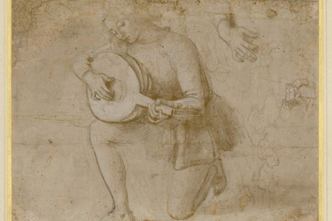 Young man playing the lute and studying details of his hands