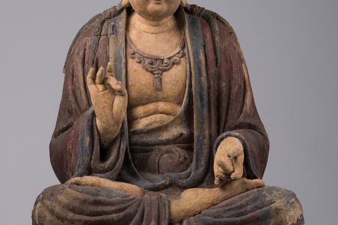 Bodhisattva assis en vitarkamudrā