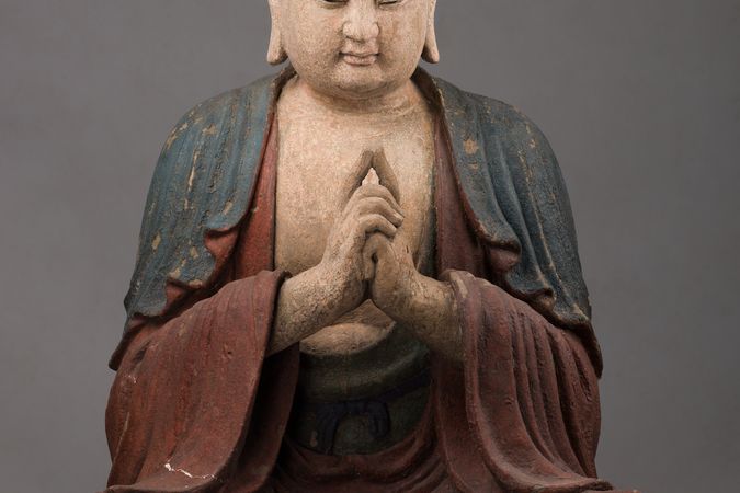 Bouddha assis les mains jointes