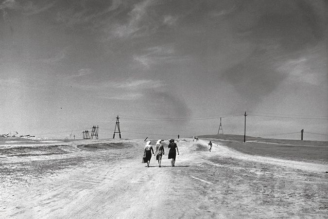 Women walking in a desert landscape