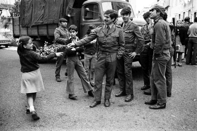 Young soldiers receive a floral tribute from a little girl, Lisbon