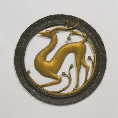 Golden circular tile depicting deer