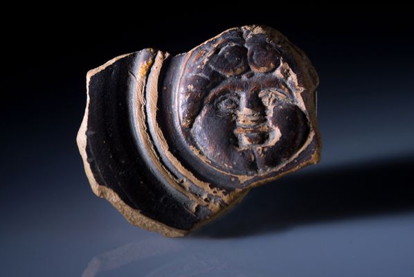 Schwarz lackiertes Guttus-Medaillon mit Gorgoneion aus der brettianischen Nekropole der Contrada Moio